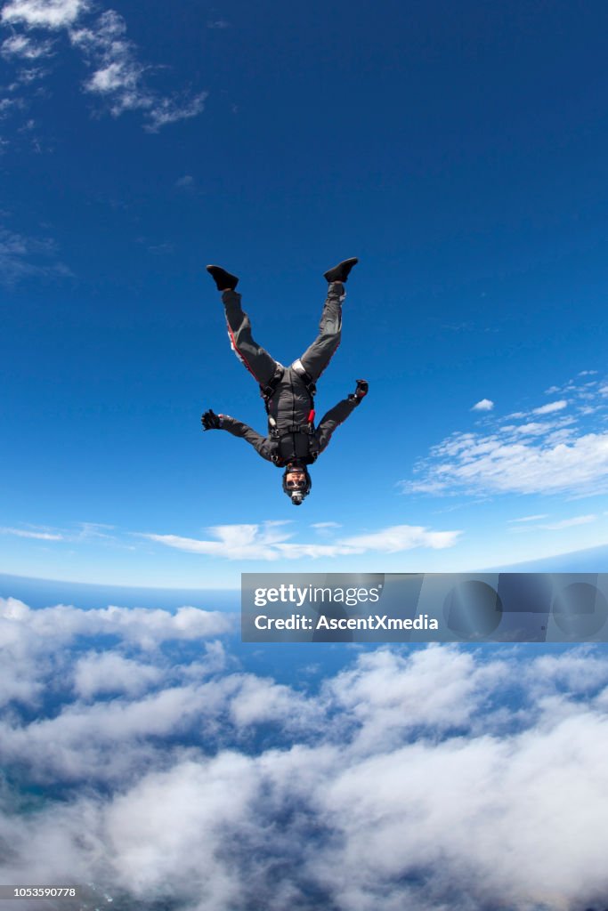 Sky diver falls through lofty skies