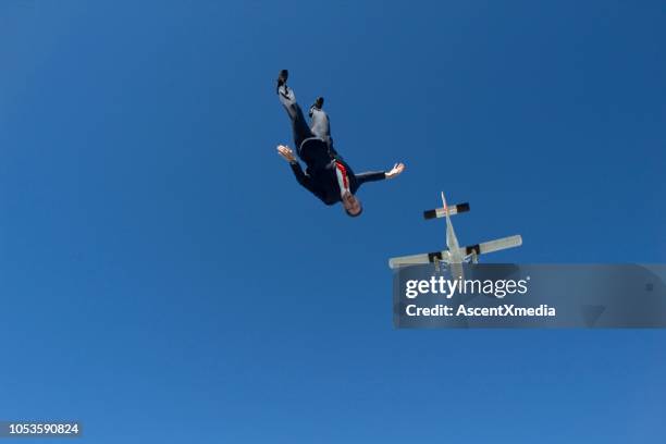 sky diver falls from plane, in business suit - aerial stunts flying stock pictures, royalty-free photos & images