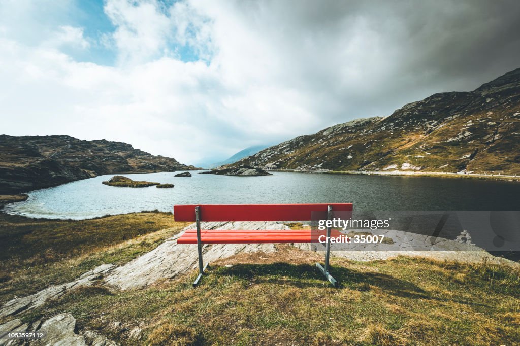 Banco rojo con un punto de vista, la montaña lago san bernardino, Suiza