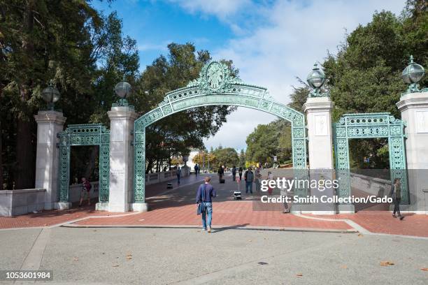 Student walk through Sather Gate, the iconic entrance gate to the campus of UC Berkeley in downtown Berkeley, California, October 9, 2018.