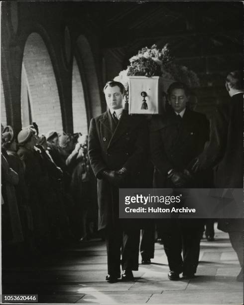 The scene inside the chapel at Golders Green Crematorium as the coffin of Ivor Novello is carried up the aisle after the funeral, 12th May 1951....