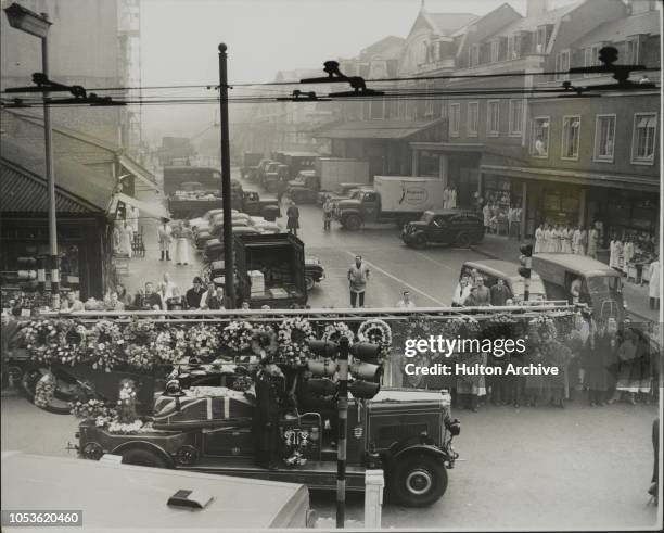 Smithfield Market workers in silent tribute, as the funeral cortege passes along Farringdon Road in London, bearing the coffins of two firemen on...