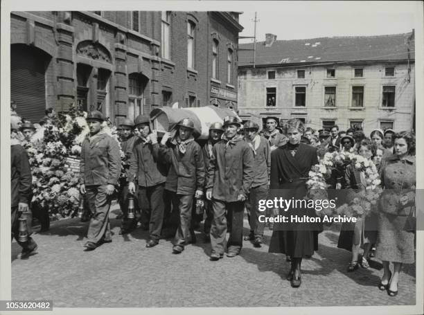 Large crowd attends the funeral, as colleagues makes their way to the cemetery carrying the coffins of six of the 11 miners recovered from the Bitter...