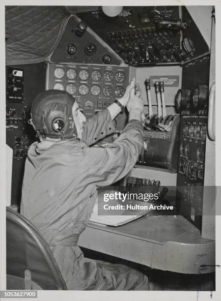 Engineer Ginsberg from Pontefract manipulates the complicated looking set of instruments on the flight deck of a Hastings, Pontefract.
