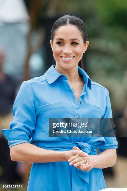 Prince Harry, Duke of Sussex and Meghan, Duchess of Sussex walking over to participate in the Unveiling of The Queen's Commonwealth Canopy at Tupou...
