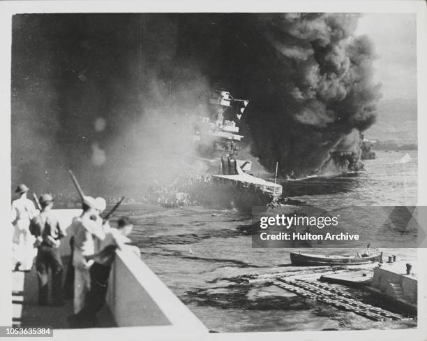 Ships of the US Pacific Fleet on fire during the Attack by Japanese forces, on Pearl Harbor in Honolulu, Oahu, Hawaii, December 7, 1941.