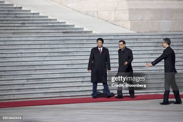 Shinzo Abe, Japan's prime minister, left, and Li Keqiang, China's premier, attend a welcome ceremony at the Great Hall of the People in Beijing,...