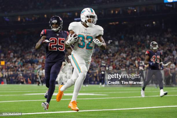 Kenyan Drake of the Miami Dolphins catches a pass and scores a touchdown defended by Kareem Jackson of the Houston Texans in the third quarter at NRG...