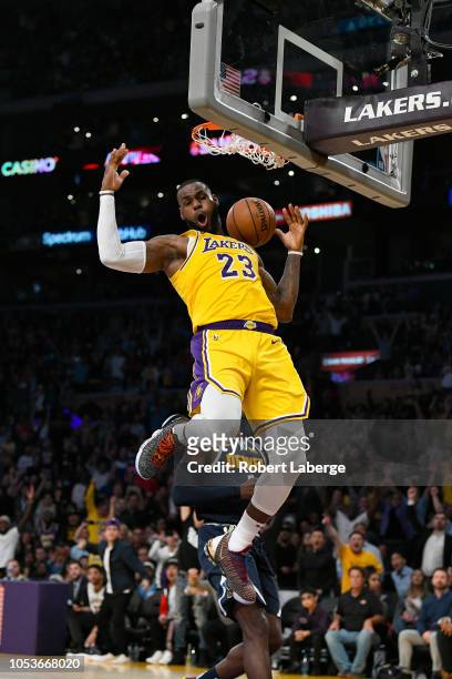 LeBron James of the Los Angeles Lakers dunks the basketball against Paul Millsap of the Denver Nuggets on October 25, 2018 at STAPLES Center in Los...