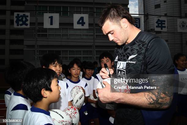 Liam Squire signs autographs during a New Zealand All Blacks visit the Shiba Elementary School on October 26, 2018 in Tokyo, Japan.