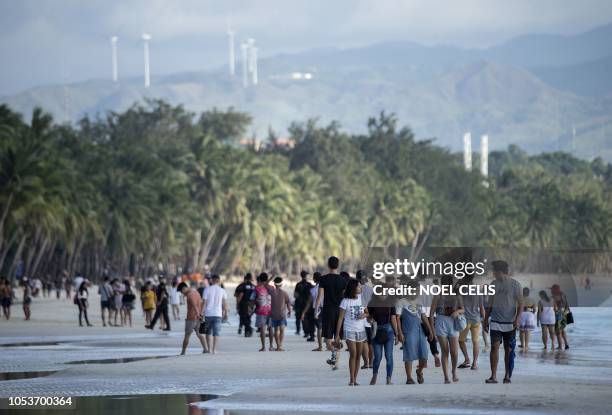 Tourists visit a beach on the Philippine island of Boracay on October 26, 2018. - Tourists landed by the boatload on October 26 on the Philippines'...