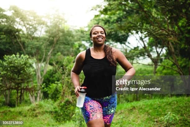 body positive woman exercising in nature - fat people stock pictures, royalty-free photos & images