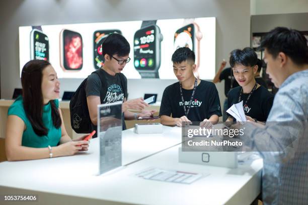 Customer purchases iPhones and an Apple Watch at the Apple store during the launch of the iPhone XS on October 26, 2018 in Kuala Lumpur, Malaysia....