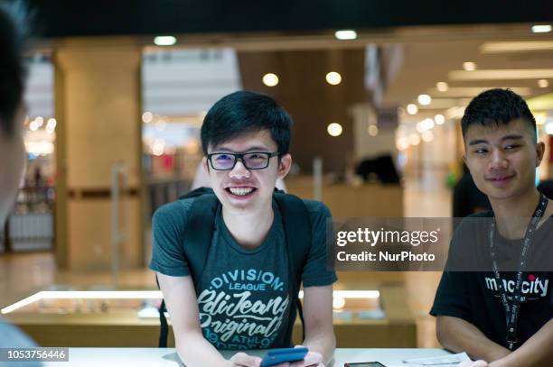 Customer purchases iPhones and an Apple Watch at the Apple store during the launch of the iPhone XS on October 26, 2018 in Kuala Lumpur, Malaysia....