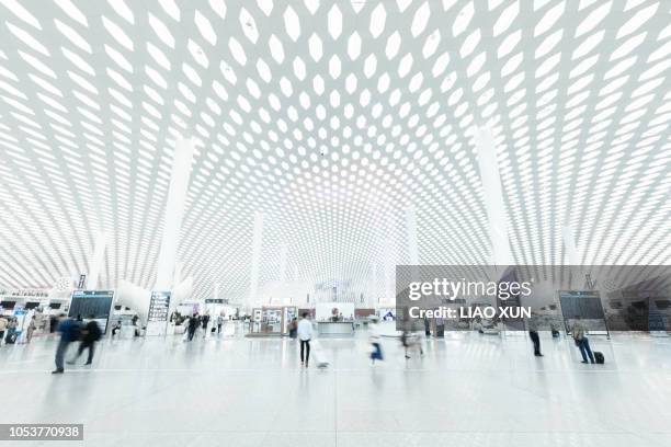 blurred people in a modern airport terminal check-in area - shenzhen stock pictures, royalty-free photos & images
