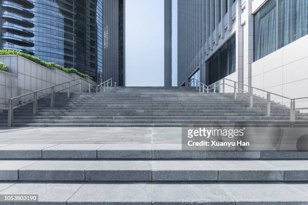 steps front of modern building in city of china. - low angle view of silhouette palm trees against sky stockfoto's en -beelden