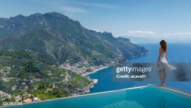 italy. amalfi coast. woman in infinity pool. - italian villa stock pictures, royalty-free photos & images