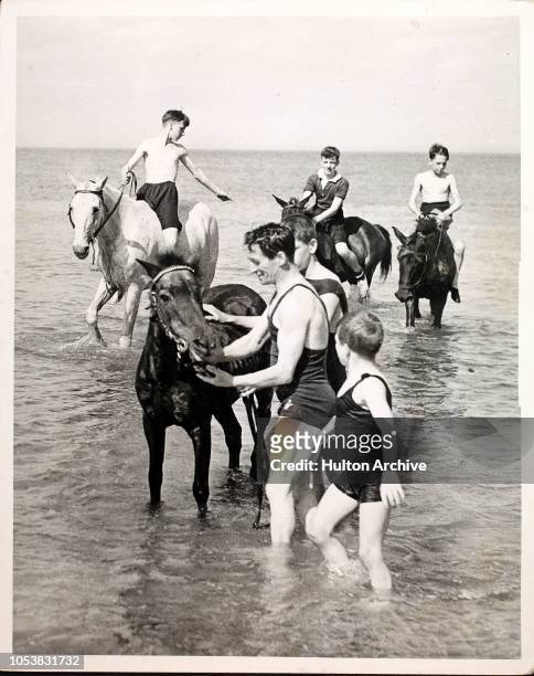 Members of the Scottish Boys Brigade horse riding on the beach whilst camping on the quiet coast of County Down at Ganaway, the camping ground of the...