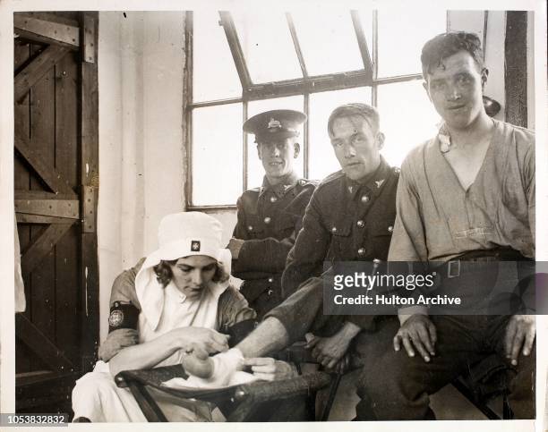Nurse attends to an injured member of the Leicester Territorials at Ripon Camp, UK, circa 1935. It is understood that this is the first time that...