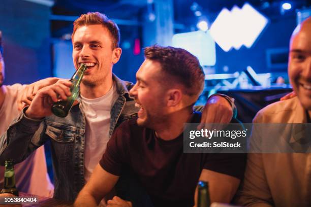 group of men with their drinks from the bar - man party night bar posing stock pictures, royalty-free photos & images