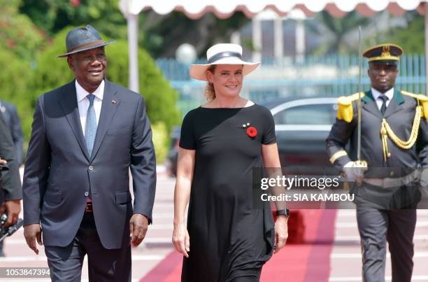 Ivory Coast president Alassane Ouattara walks with Canada Governor General Julie Payette during a welcome ceremony at the Presidential Palace in...