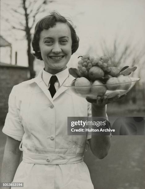 Miss Claire Swan of Sydney, Australia, learns to hold a fruit bowl in flight at the BOAC Air Stewardesses Training School in Heston, 19th January...