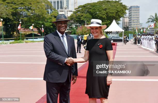 Ivory Coast president Alassane Ouattara shakes hands with Canada Governor General Julie Payette upon her arrival at the Presidential Palace in...