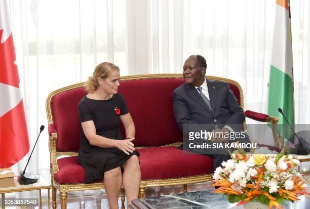 Ivory Coast president Alassane Ouattara and Canada Governor General Julie Payette talk upon her arrival at the Presidential Palace in Abidjan on...