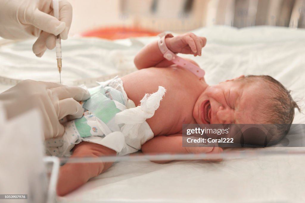 Doctor examines a newborn baby