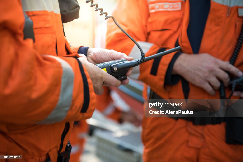 Firefighters using walkie talkie, rescue operation Close Up