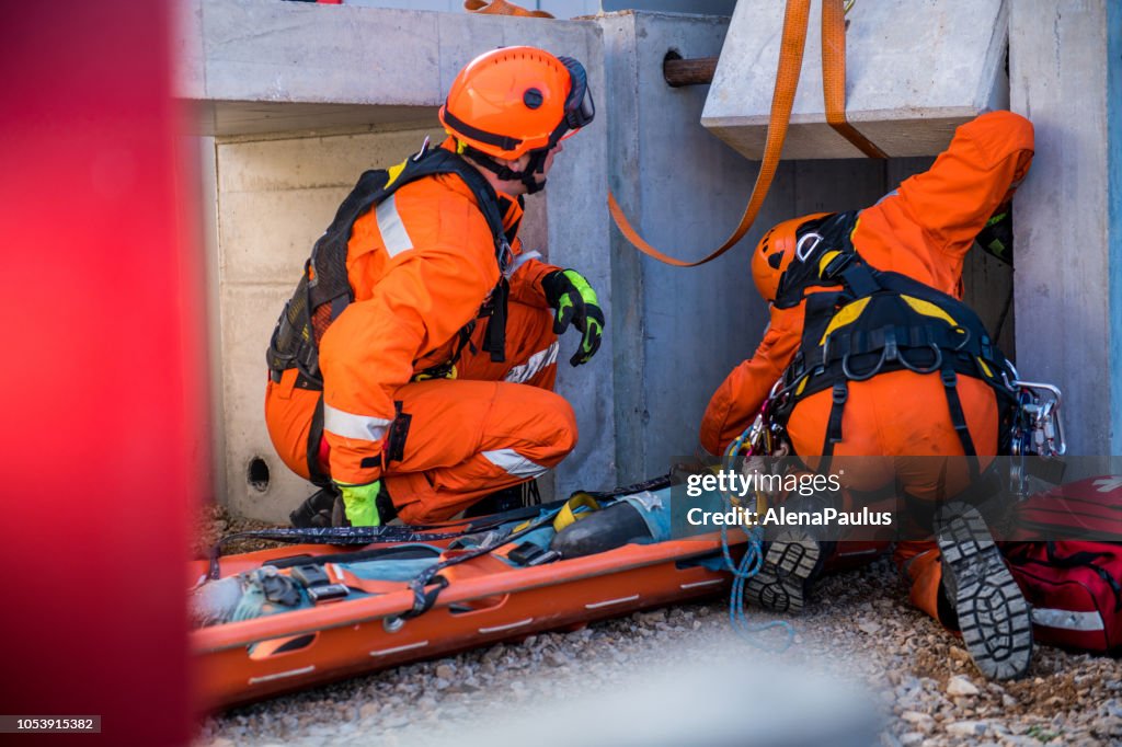 Rescuing injured person from the ruins, firefighters rescue operation