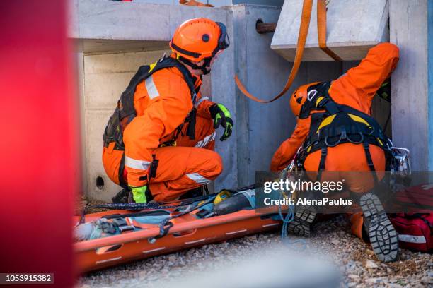 rescuing injured person from the ruins, firefighters rescue operation - injured worker stock pictures, royalty-free photos & images