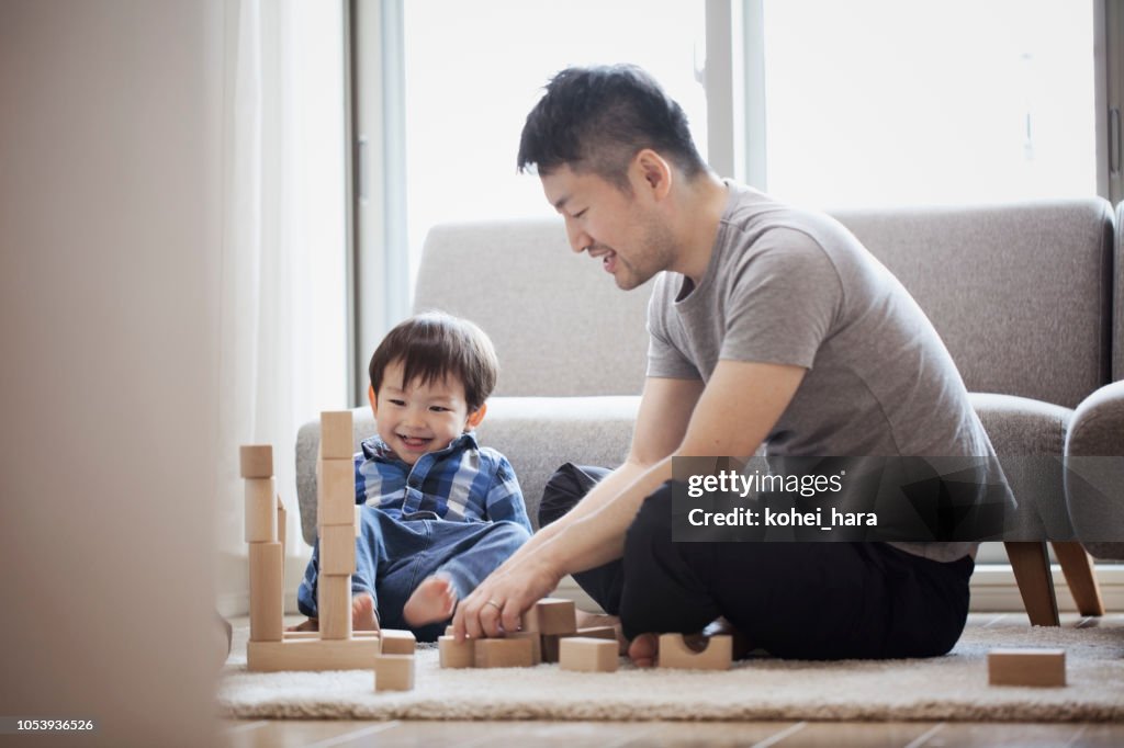 Father and son playing with building blocks together