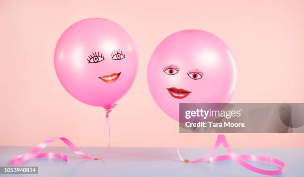 helium balloons with smiling faces floating - stereotypical stock pictures, royalty-free photos & images