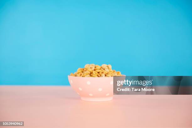 bowl of cereal with blue and pink background - cereals fotografías e imágenes de stock