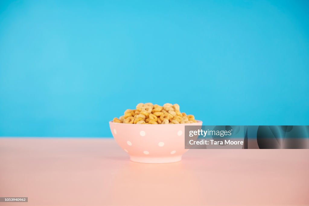 Bowl of cereal with blue and pink background