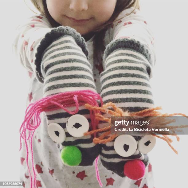 girl playing with puppets made with socks - puppet stock pictures, royalty-free photos & images