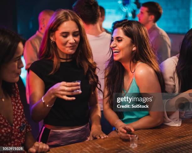 women laughing at her friends taking shots - shot glass stock pictures, royalty-free photos & images
