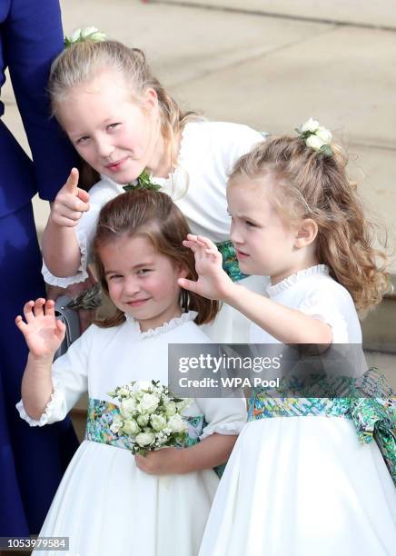 Bridesmaids Princess Charlotte of Cambridge, Savannah Phillips and Maud Windsor wave off Princess Eugenie of York and Mr. Jack Brooksbank following...