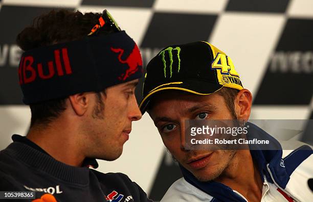Andrea Dovizioso of Italy and the Repsol Honda Team talks with Valentino Rossi of Italy and the Fiat Yamaha Team during a press conference prior to...