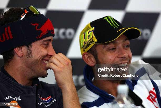 Andrea Dovizioso of Italy and the Repsol Honda Team laughs with Valentino Rossi of Italy and the Fiat Yamaha Team during a press conference prior to...