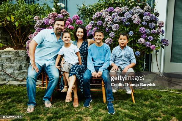 portrait of family in backyard garden on summer evening - five people stock pictures, royalty-free photos & images