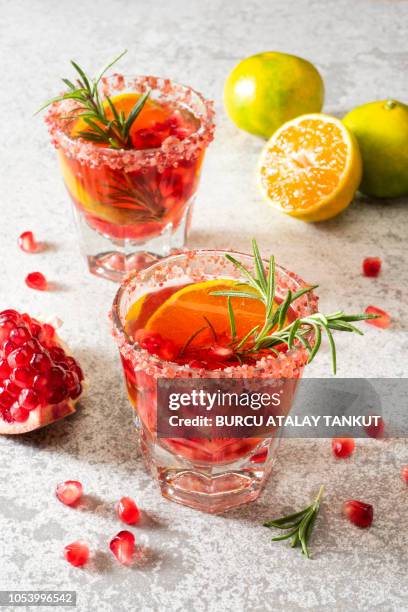 pomegranate drink with tangerine and rosemary - gin stock-fotos und bilder