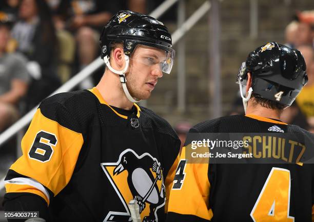 Jamie Oleksiak of the Pittsburgh Penguins talks with Justin Schultz during the game against the Montreal Canadiens at PPG Paints Arena on October 6,...