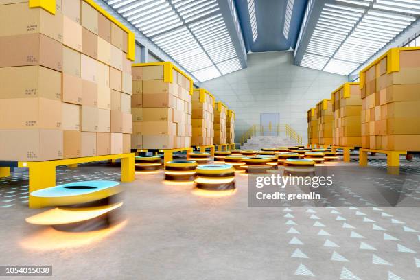 automated robot carriers in modern distribution warehouse - distribution warehouse stock pictures, royalty-free photos & images