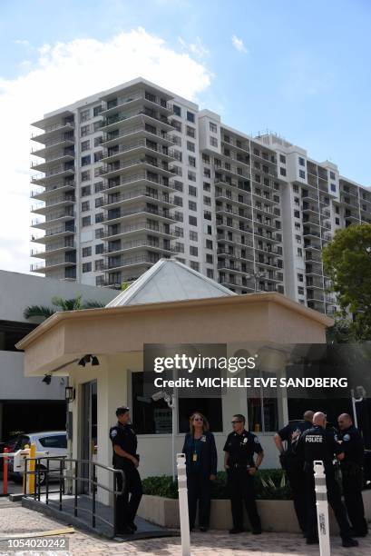 Police guard the entrance to the Clipper Apartment Building at Biscayne Cove, Florida, on October 26, 2018. - The building reportedly has been...