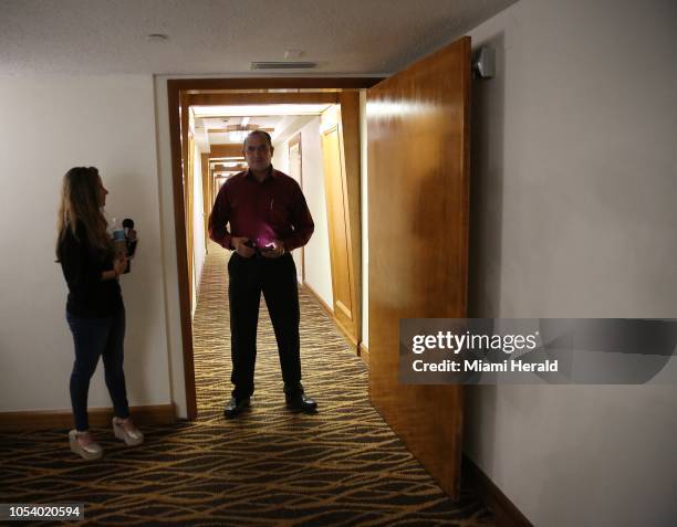 Reporter speaks to a man standing guard in the hallway of the Aventura condo at 18151 NE 31st Ct. Apt. Where 56 year-old Cesar Sayoc was reported to...