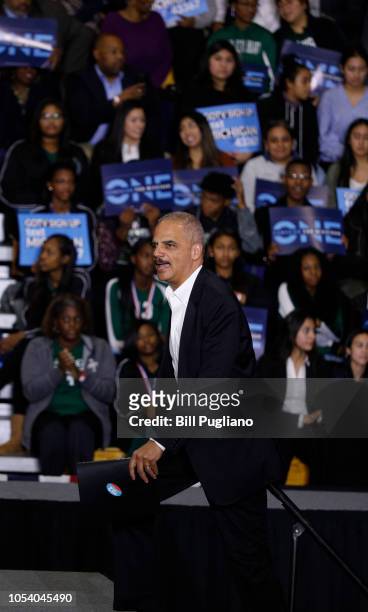 Former Attorney General Eric Holder walks on stage to speak at a rally to support Michigan democratic candidates at Cass Tech High School on October...