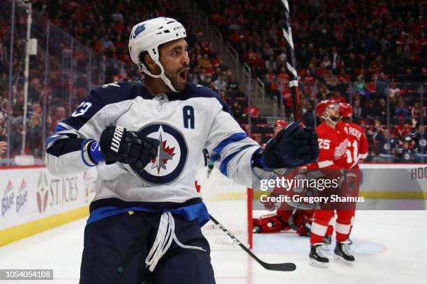 Dustin Byfuglien of the Winnipeg Jets celebrates his third period goal while paying the Detroit Red Wings at Little Caesars Arena on October 26, 2018...