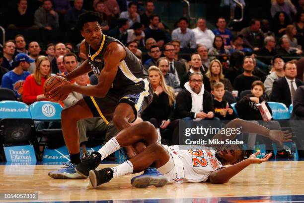 Noah Vonleh of the New York Knicks collides with Damian Jones of the Golden State Warriors at Madison Square Garden on October 26, 2018 in New York...